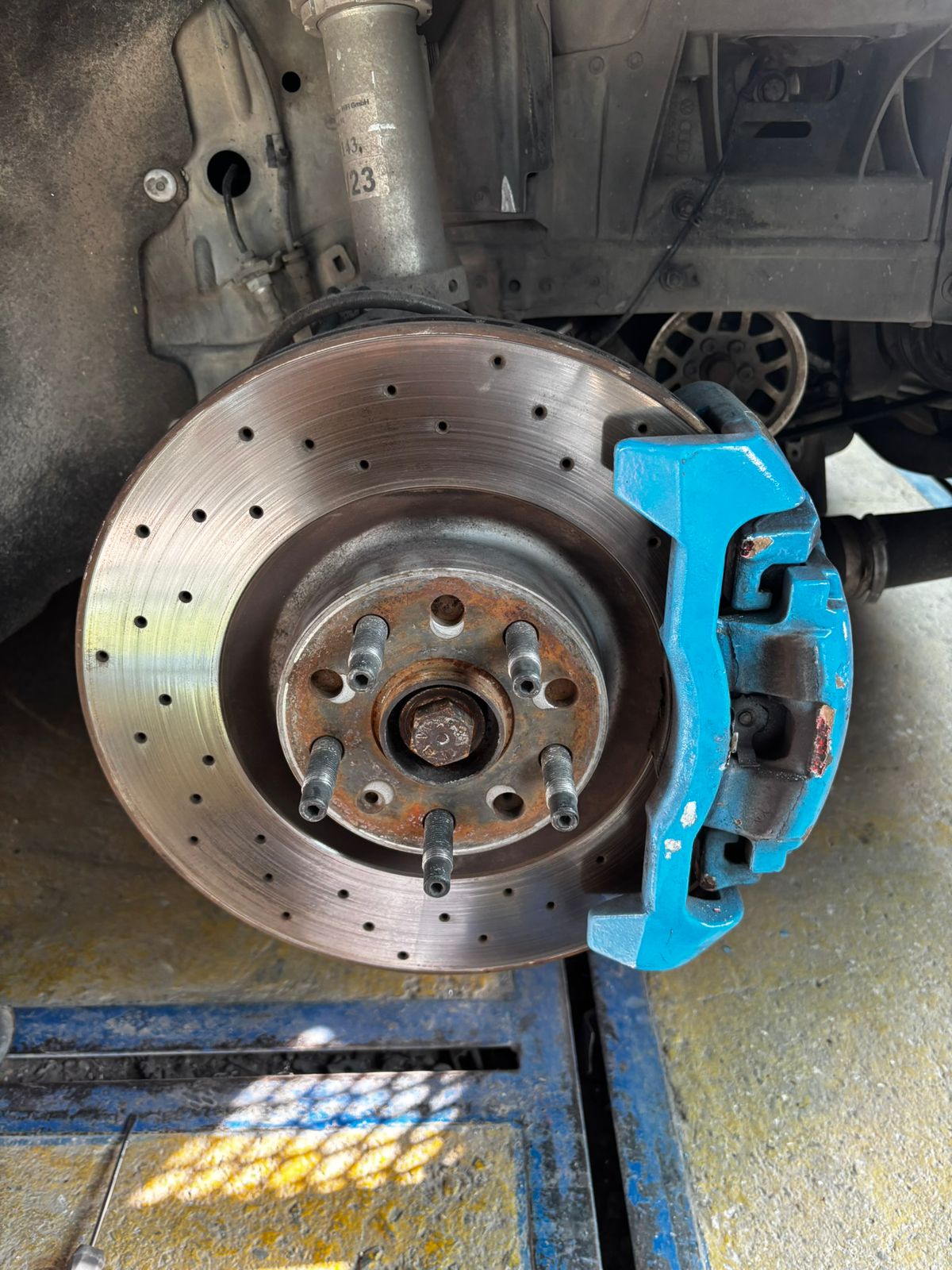 Blue caliper on drilled disc